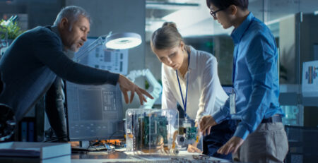 Three people having a discussion about technology