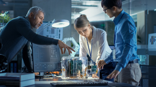 Three people having a discussion about technology