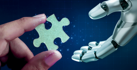 Human hand handing a robot hand a puzzle piece